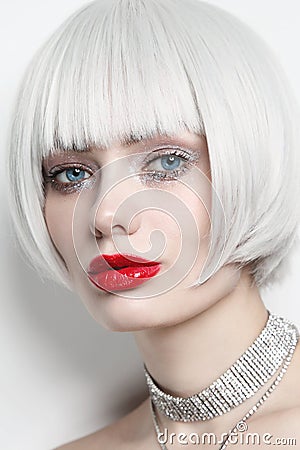 Vintage style portrait of beautiful woman with platinum blonde hair and red lips Stock Photo