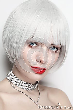 Vintage style portrait of beautiful woman with platinum blonde hair and red lips Stock Photo