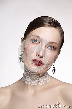 Vintage style portrait of young woman with fancy makeup and lace chocker Stock Photo