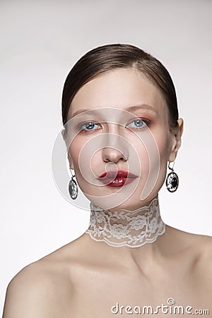 Vintage style portrait of young woman with fancy makeup and lace chocker Stock Photo