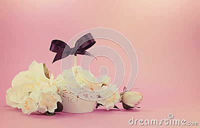 Vintage style retro filter white cupcake with floral decoration Stock Photo