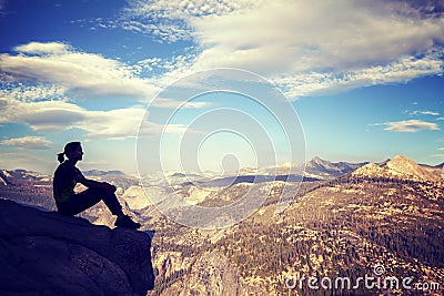 Vintage stylized silhouette of a woman watching mountain view. Stock Photo