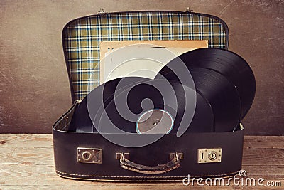 Vintage suitcase with old music records Stock Photo