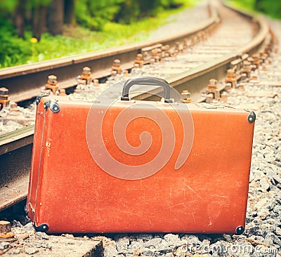 Vintage suitcase standing beside the railway Stock Photo