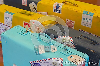 Vintage suitcases with stickers of the invented agencies close-up Stock Photo