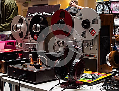 Vintage tape players, tube amplifier, headphones on stand, vinyl records at the international exhibition HI-FI & HIGH END SHOW Editorial Stock Photo