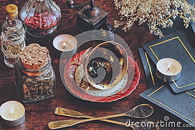 Vintage teacup laying on it`s side on a wiccan witch altar for reading tea leaves as a method of divination Stock Photo