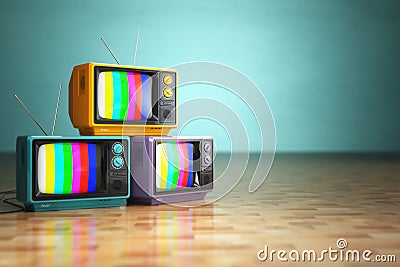 Vintage television concept. Stack of retro tv set on green background. Stock Photo