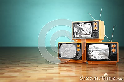 Vintage television concept. Stack of retro tv set on green backg Stock Photo