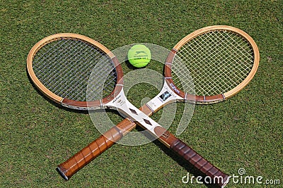 Vintage Tennis rackets and Slazenger Wimbledon Tennis Ball on grass tennis court. Editorial Stock Photo