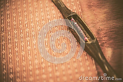 Vintage Thai silk work with weaving tool. Stock Photo