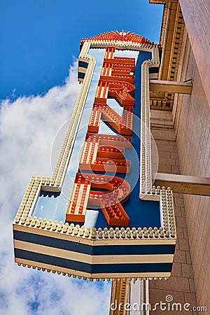 Vintage Theatre Marquee Sign in Bright Red with Light Bulbs Against Blue Sky Editorial Stock Photo