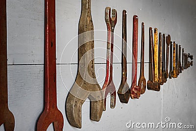 Vintage Tools Hung in Row on Wall Stock Photo