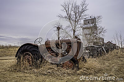Vintage tractor with the Coderre, Saskatchewan elevator in background Stock Photo