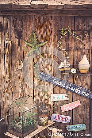 Vintage travel still life on old wooden fence with rope, starfish, compass, wooden signs and accessories Stock Photo