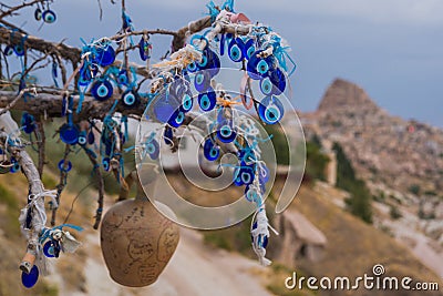 A vintage tree decorated with non-commercial Evil Eyes pots Cappadocia. Uchisar. Evil Eye is a Turkish traditional ornament dating Stock Photo