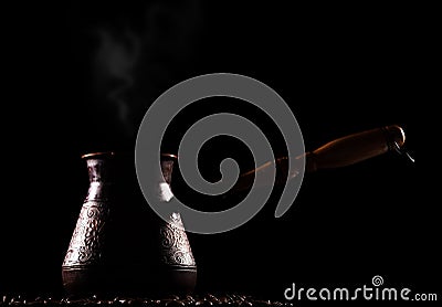 Vintage turkish coffee cezve isolated on black Stock Photo