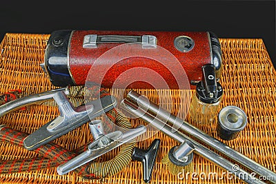 Vintage vacuum cleaner. Retro vacuum cleaner vintage with accessories on wicker box. Black background Stock Photo