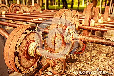 Vintage view of rusty old operational barbells mounted on the stand in public park Stock Photo