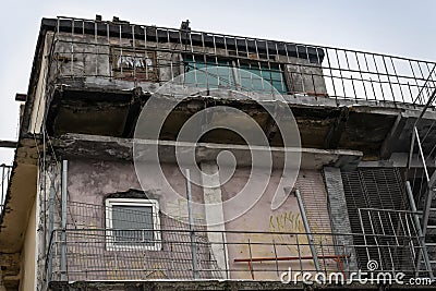Vintage, weathered rough exterior house, aged weathered faded moldy building, crumbling facade Stock Photo