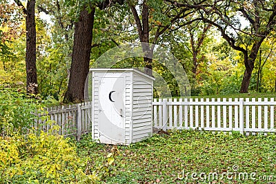 Vintage White Outhouse in Rural United States Stock Photo