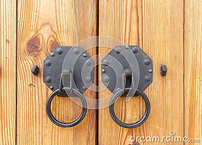 Vintage wooden gate with two door knocker closeup Stock Photo