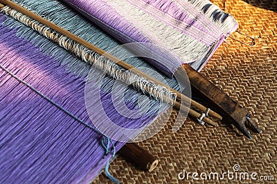 Vintage wooden parts of the loom with purple woven cloth on background, Inle lake, Myanmar Stock Photo