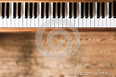 Vintage wooden piano. Keys in the foreground, wooden floor with text space in the blurry background Stock Photo