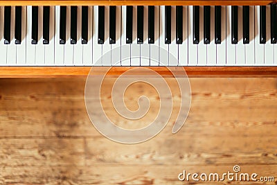 Vintage wooden piano. Keys in the foreground, wooden floor with text space in the blurry background Stock Photo