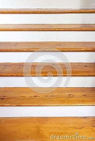Vintage wooden stair with brown plank tread and white riser. Wood shelf on white painted wall Stock Photo