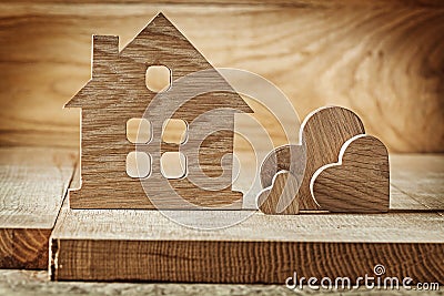 Vintage wooden toys house and three hearts on wood background Stock Photo