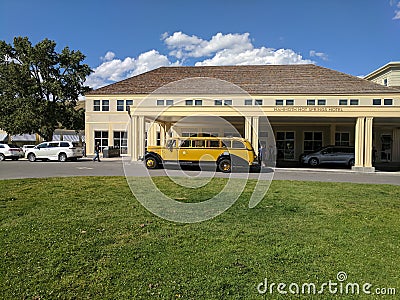 Vintage bus parked in front of Mammoth Hot Springs Hotel at Yellowstone National Park Editorial Stock Photo