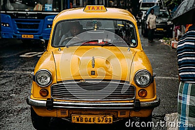 Vintage yellow taxi waiting for passenger near Mullick Ghat Flower Market in Kolkata, India Editorial Stock Photo
