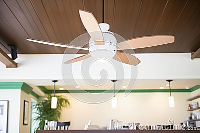 vintageinspired ceiling fan with lights in a caf Stock Photo