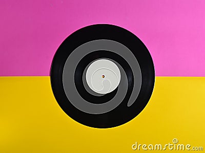 Vinyl plate on a colored pastel background, retro music technology, top view, minimalism. Stock Photo