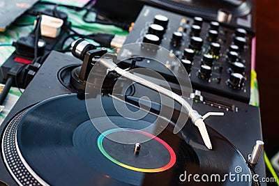 Vinyl record on a deejay`s turntable with mixing desk equipment sound system Stock Photo