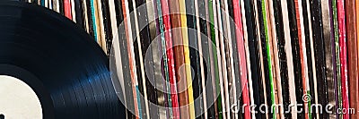 Vinyl record in front of a collection of albums, music concept Stock Photo