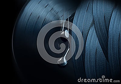 Vinyl records and black earphones on a black background. Retro sound and music instruments Stock Photo