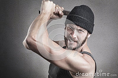 Violent man using a spanner or wrench as a weapon Stock Photo