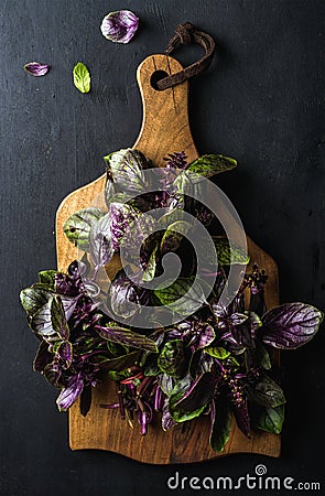 Violet basil bunch on wooden chopping board Stock Photo
