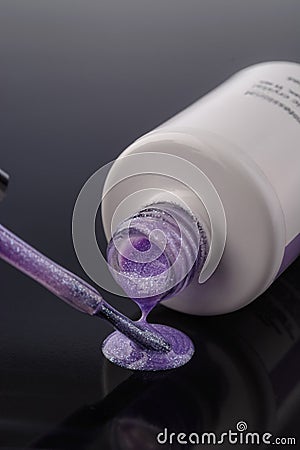 Violet nail polish with shimmer on grey background Stock Photo