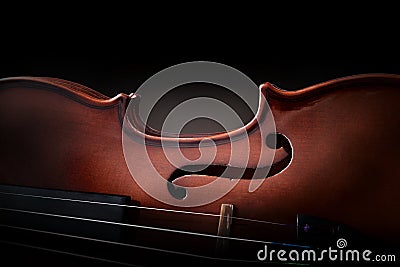 Violin body and strings detail with dark background Stock Photo