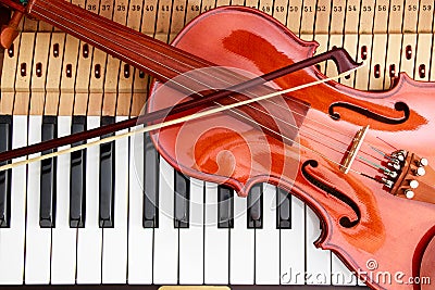 Violin and violin arc on the piano keys background Stock Photo