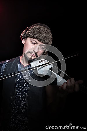 Violinist in the hat playing violin Stock Photo