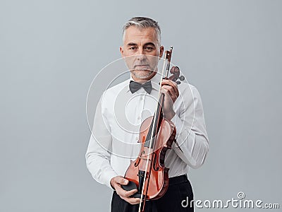 Violinist posing with his violin Stock Photo