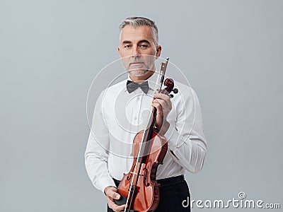 Violinist posing with his violin Stock Photo