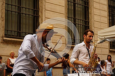 Rome, Italy - July 27, 2020: Italian violinist of a jazz street band Editorial Stock Photo