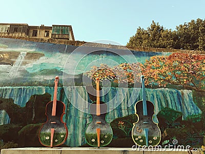 Violins in the street and painted wall Editorial Stock Photo
