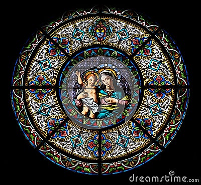 Virgin Mary with baby Jesus, stained glass window in the Cathedral of Saint Lawrence in Lugano Editorial Stock Photo