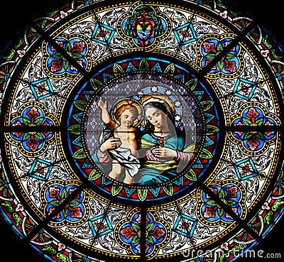 Virgin Mary with baby Jesus, stained glass window in the Cathedral of Saint Lawrence in Lugano Editorial Stock Photo